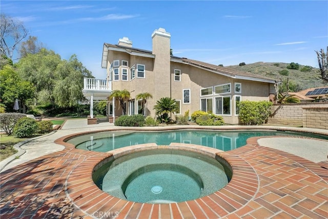 view of pool featuring a patio and a pool with connected hot tub