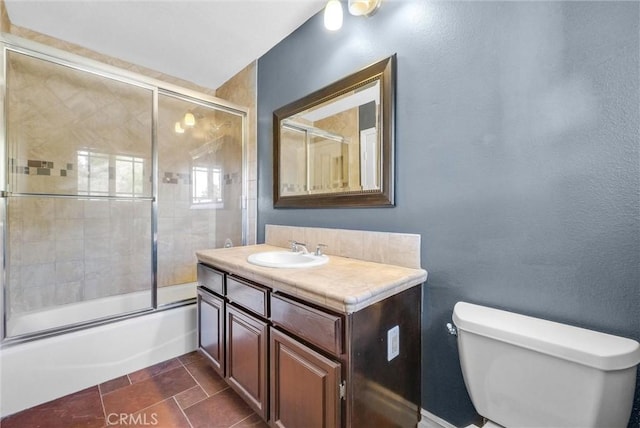 full bath featuring bath / shower combo with glass door, vanity, and toilet