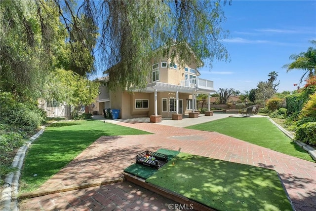 rear view of property with fence, a patio, a pergola, a lawn, and stucco siding