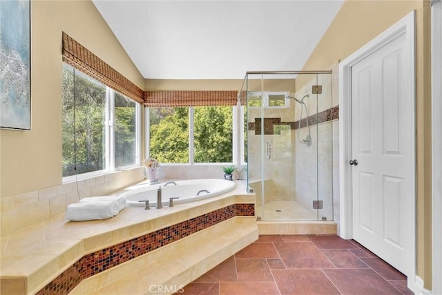 full bathroom with lofted ceiling, a garden tub, and a stall shower