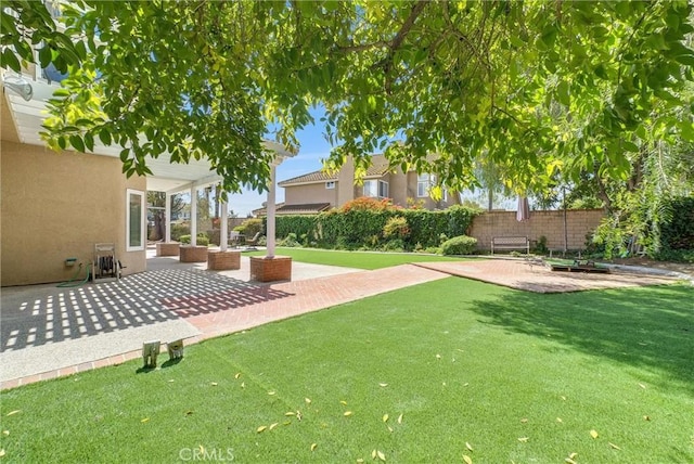 view of yard featuring fence and a patio area