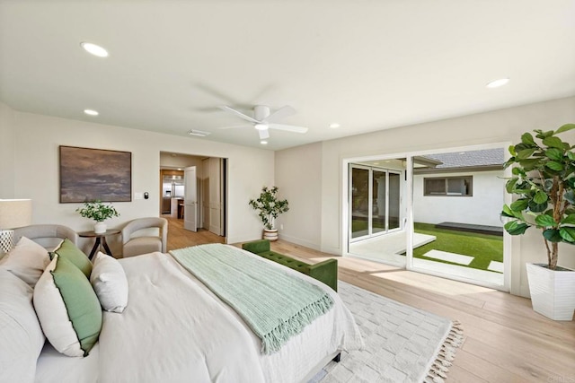 bedroom with recessed lighting, access to exterior, and wood finished floors