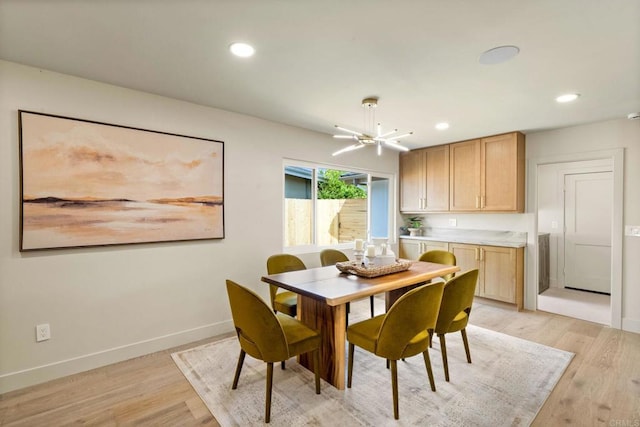 dining area with recessed lighting, an inviting chandelier, baseboards, and light wood-style floors