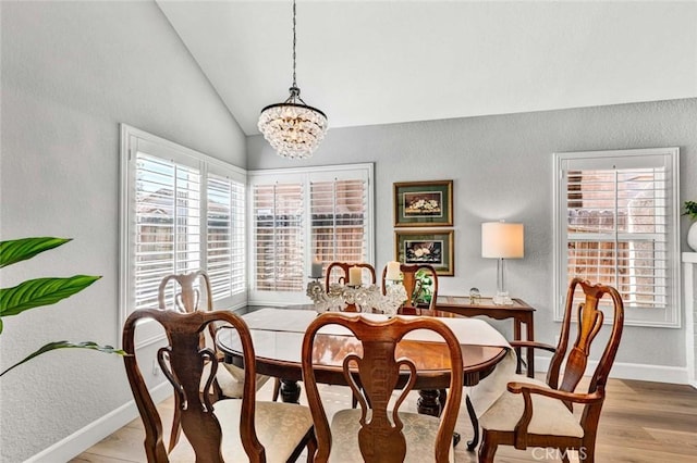 9 Las Piedras, Rancho Santa Margarita, CA 92688 - dining space featuring vaulted ceiling, light wood-style flooring, baseboards, a textured wall, and an inviting chandelier