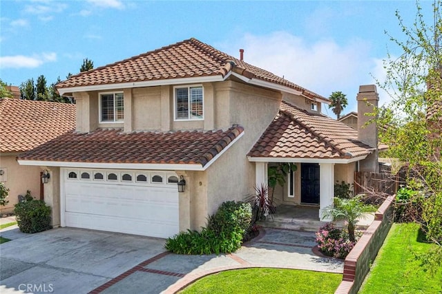 9 Las Piedras, Rancho Santa Margarita, CA 92688 - mediterranean / spanish-style home featuring a tile roof, driveway, a chimney, stucco siding, and a garage
