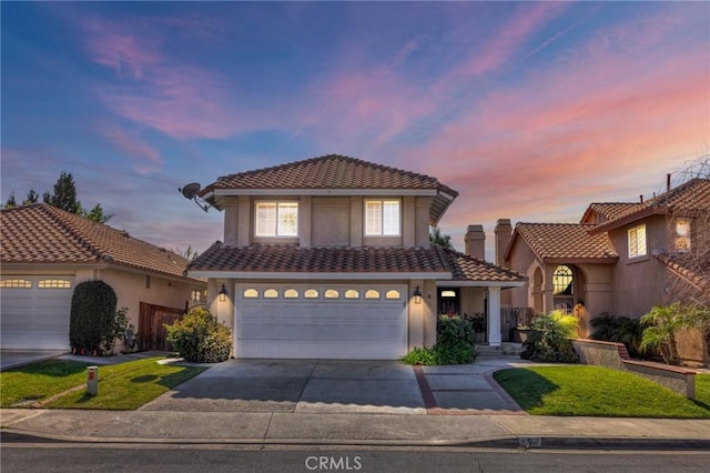 9 Las Piedras, Rancho Santa Margarita, CA 92688 - view of front facade with a tile roof, concrete driveway, stucco siding, and an attached garage