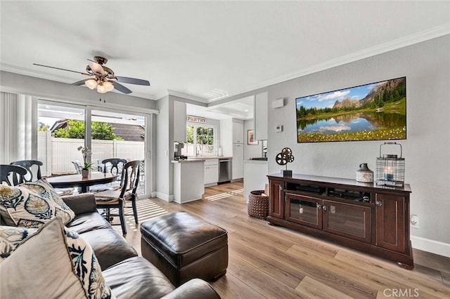 9 Las Piedras, Rancho Santa Margarita, CA 92688 - living room with light wood-style flooring, crown molding, baseboards, and ceiling fan