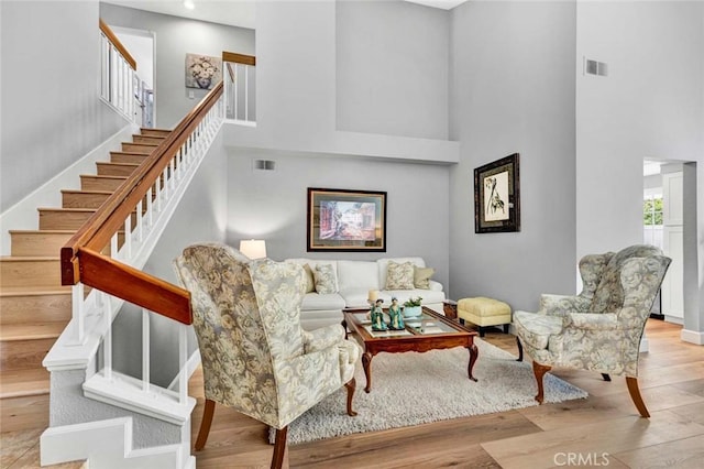 9 Las Piedras, Rancho Santa Margarita, CA 92688 - living area featuring visible vents, wood finished floors, a towering ceiling, and stairway