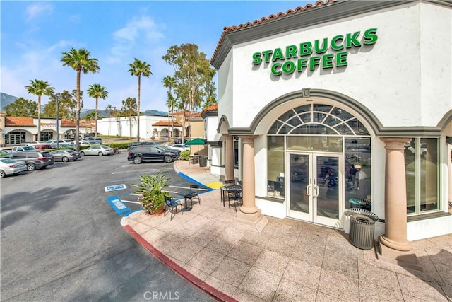 9 Las Piedras, Rancho Santa Margarita, CA 92688 - property entrance with stucco siding, uncovered parking, and french doors