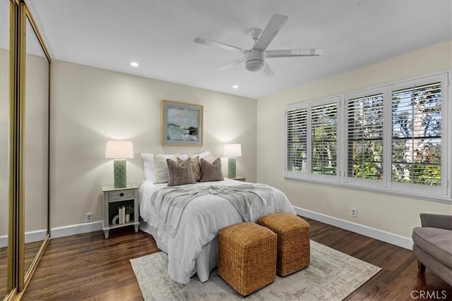 bedroom with multiple windows, baseboards, and dark wood-style flooring