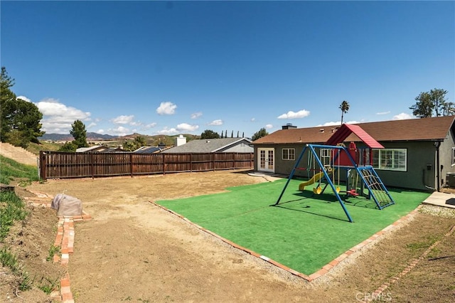 view of play area with a fenced backyard and french doors