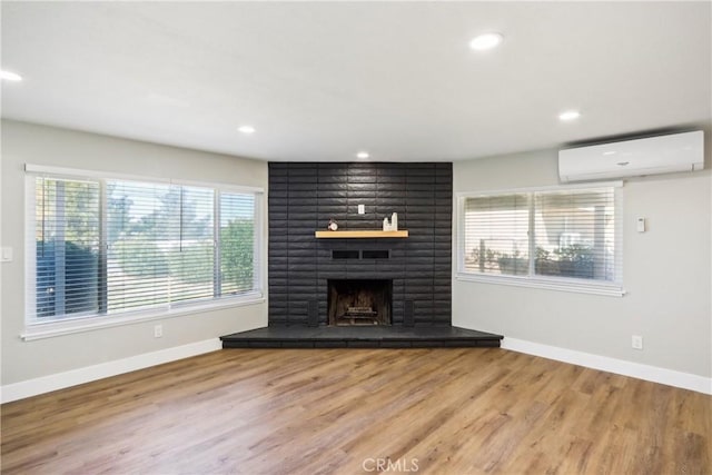 16621 Verano St, Hesperia, CA 92345 - unfurnished living room with a wall unit AC, plenty of natural light, baseboards, wood finished floors, and recessed lighting