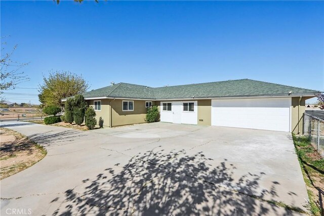 16621 Verano St, Hesperia, CA 92345 - ranch-style house featuring stucco siding, concrete driveway, fence, and an attached garage