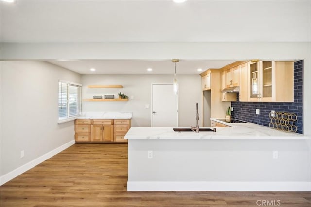 16621 Verano St, Hesperia, CA 92345 - kitchen with a peninsula, a sink, under cabinet range hood, open shelves, and light brown cabinetry