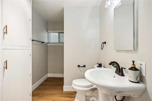 16621 Verano St, Hesperia, CA 92345 - bathroom featuring baseboards, wood finished floors, and toilet