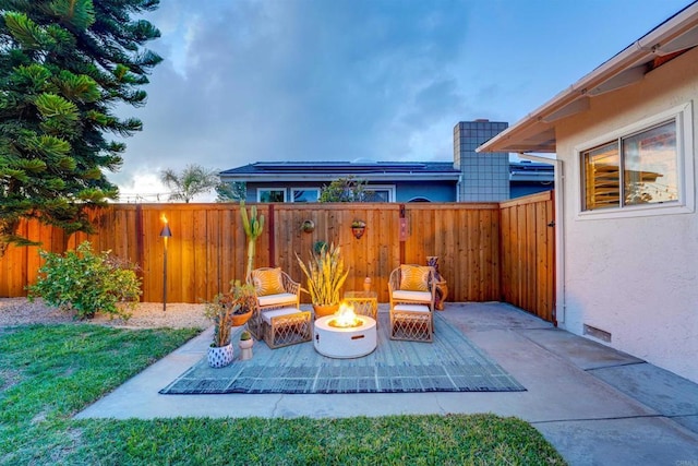 view of patio with a fenced backyard and an outdoor fire pit