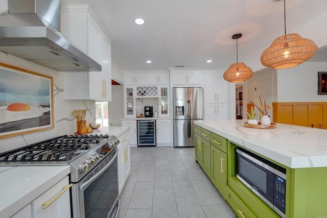 kitchen with beverage cooler, green cabinetry, appliances with stainless steel finishes, wall chimney range hood, and white cabinets