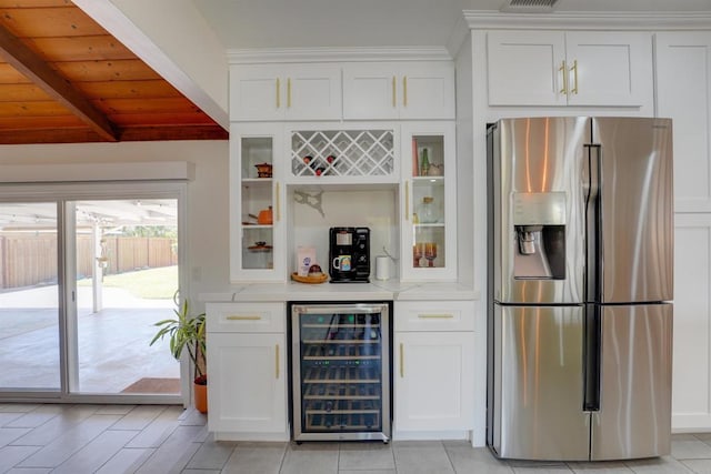 bar with beverage cooler, wooden ceiling, stainless steel fridge, beam ceiling, and a bar