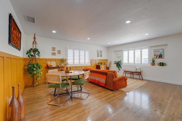 interior space with visible vents, a wainscoted wall, light wood finished floors, and recessed lighting