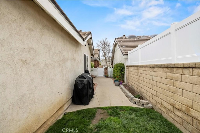 view of home's exterior featuring a patio, a fenced backyard, and stucco siding