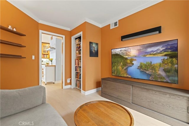 living room featuring baseboards, visible vents, wood finished floors, and ornamental molding