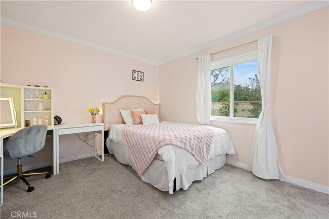 carpeted bedroom with baseboards and crown molding