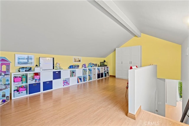 playroom featuring wood finished floors and lofted ceiling with beams