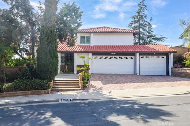27955 Gallina, Mission Viejo, CA 92692 - mediterranean / spanish home featuring a tile roof, driveway, stucco siding, an attached garage, and a porch