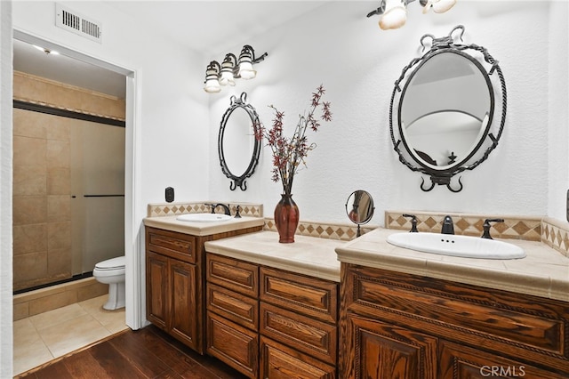 27955 Gallina, Mission Viejo, CA 92692 - bathroom featuring a stall shower, double vanity, and wood finished floors