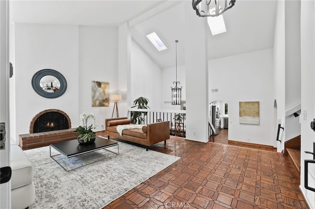 27955 Gallina, Mission Viejo, CA 92692 - living area with high vaulted ceiling, a skylight, a brick fireplace, a chandelier, and beam ceiling