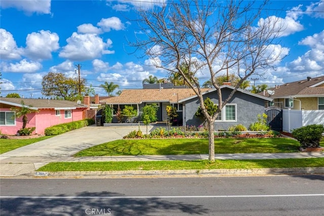single story home with stucco siding, fence, a front lawn, a gate, and concrete driveway