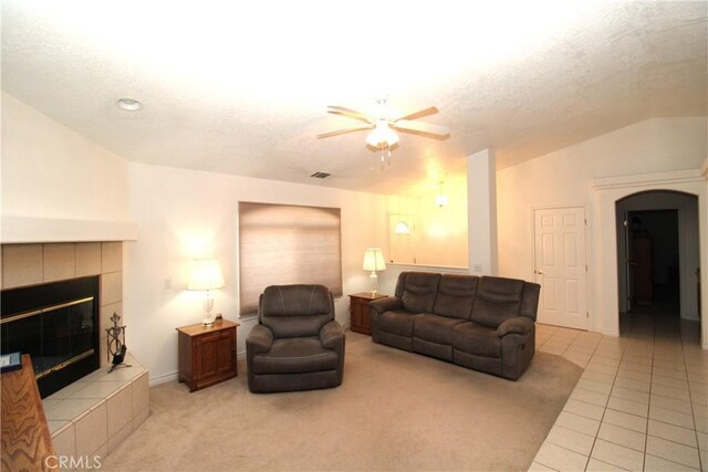 17255 Donert St, Hesperia, CA 92345 - living room with a fireplace, arched walkways, a ceiling fan, tile patterned flooring, and lofted ceiling