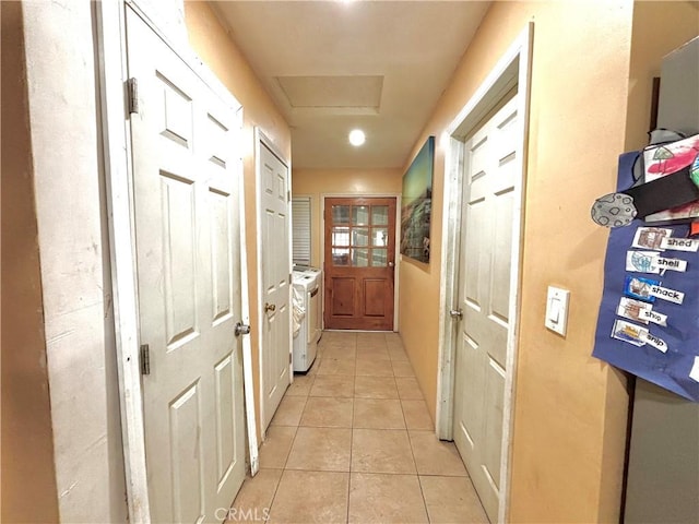 238 Kellog Ave, Fullerton, CA 92833 - hallway with washing machine and dryer, light tile patterned floors, and attic access
