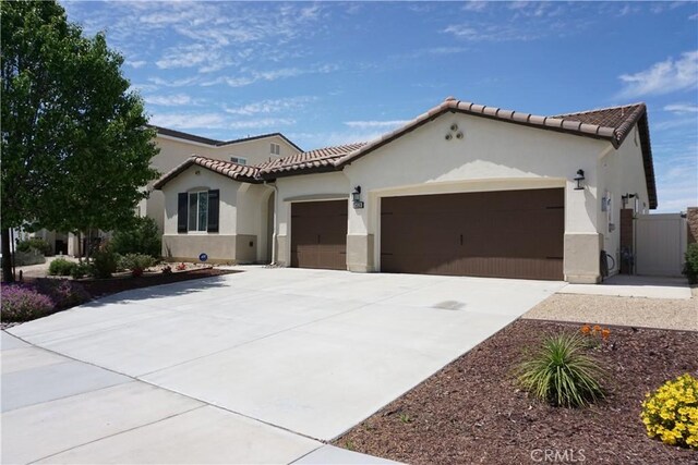 34539 Velvetleaf St, Winchester, CA 92596 - mediterranean / spanish home featuring an attached garage, stucco siding, concrete driveway, and a tiled roof