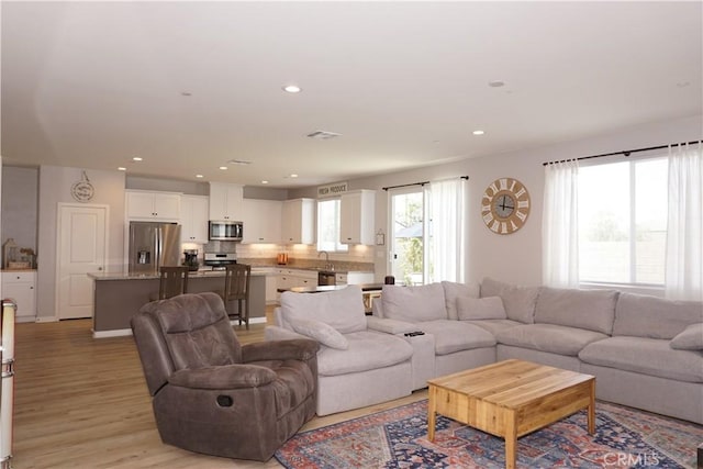34539 Velvetleaf St, Winchester, CA 92596 - living room featuring light wood-style floors and recessed lighting