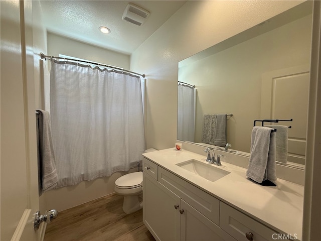 34539 Velvetleaf St, Winchester, CA 92596 - full bath with wood finished floors, toilet, vanity, shower / bath combination with curtain, and a textured ceiling