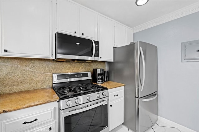 kitchen featuring stainless steel appliances, electric panel, white cabinetry, light countertops, and tasteful backsplash