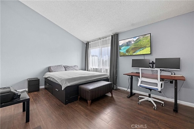 bedroom featuring a textured ceiling, vaulted ceiling, wood finished floors, and baseboards
