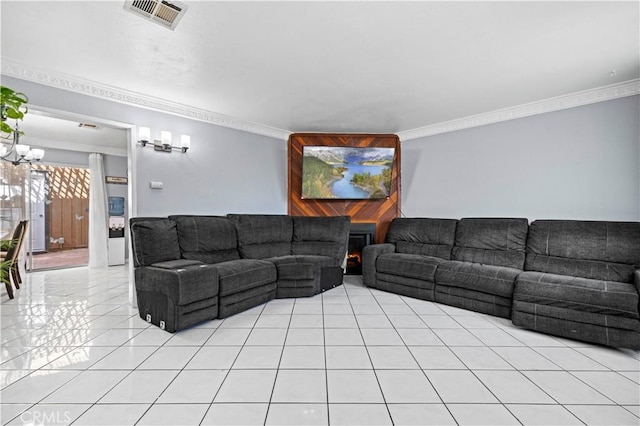 living room featuring a chandelier, ornamental molding, light tile patterned flooring, and visible vents
