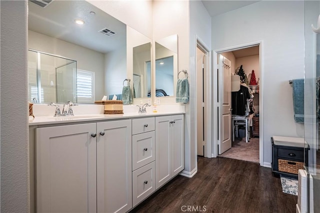28340 Memory Ln, Winchester, CA 92596 - bathroom featuring wood finished floors, a sink, a stall shower, a walk in closet, and visible vents