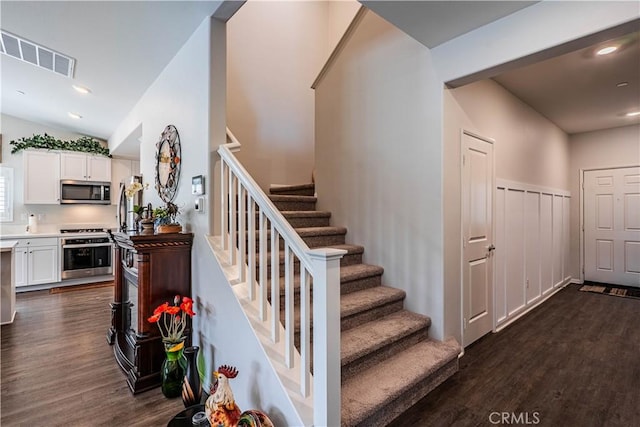 28340 Memory Ln, Winchester, CA 92596 - staircase with vaulted ceiling, wood finished floors, visible vents, and recessed lighting