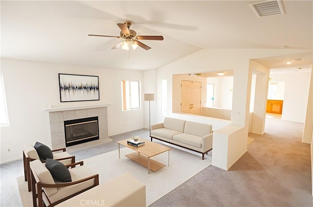 40108 Corte Lorca, Murrieta, CA 92562 - living room featuring light colored carpet, vaulted ceiling, ceiling fan, and a tiled fireplace