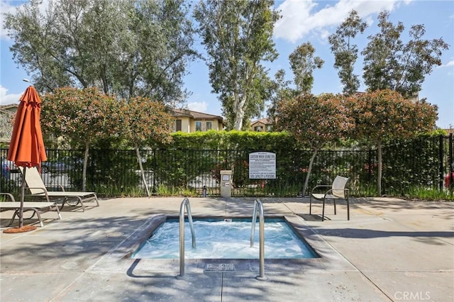 view of swimming pool with a community hot tub, fence, and a patio