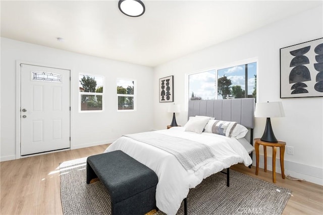 bedroom featuring baseboards and light wood-style floors