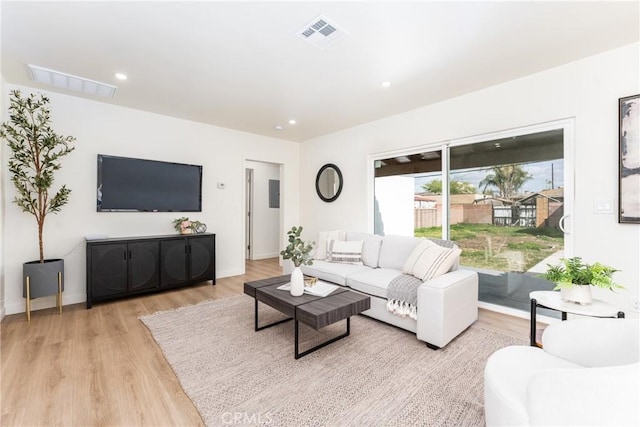 living area featuring recessed lighting, baseboards, light wood-style floors, and visible vents