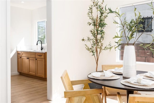 dining room featuring breakfast area and light wood-type flooring