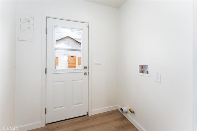 laundry room featuring baseboards, washer hookup, light wood-style flooring, and laundry area