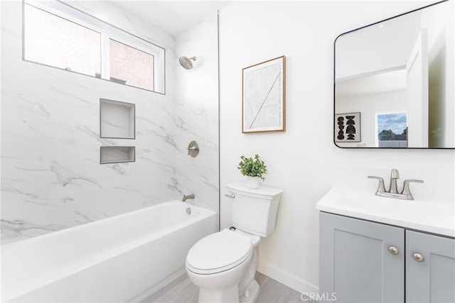 bathroom featuring baseboards, toilet, vanity, and washtub / shower combination