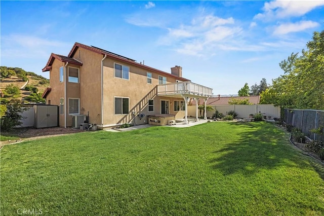 25302 Rolling Greens Way, Saugus, CA 91350 - back of house featuring a hot tub, a patio area, central AC unit, stucco siding, and a chimney