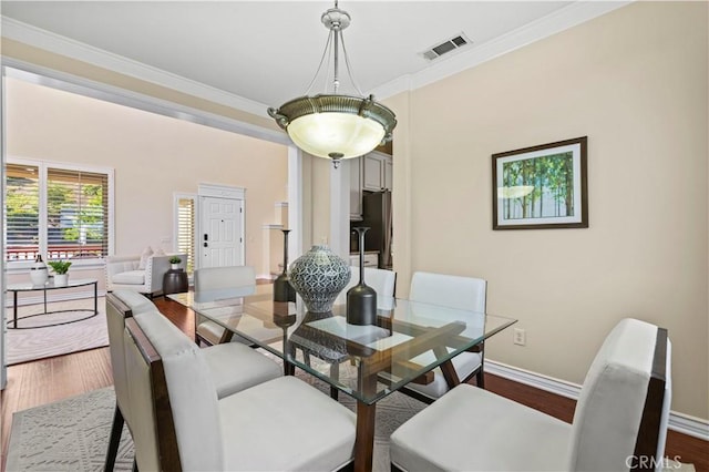 25302 Rolling Greens Way, Saugus, CA 91350 - dining space with ornamental molding, dark wood finished floors, and baseboards